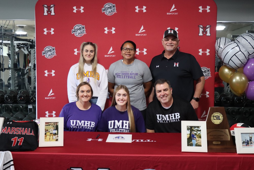 Caitlyn with her family and coaches